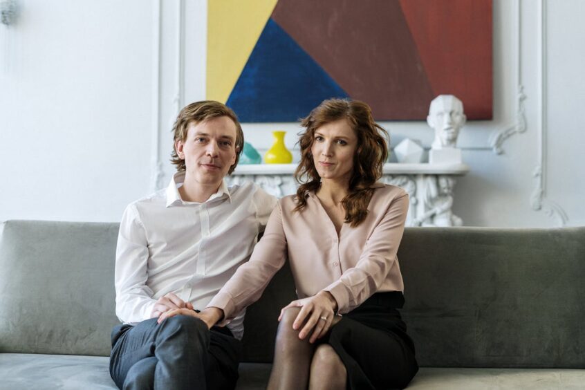 Man and woman sitting together on couch