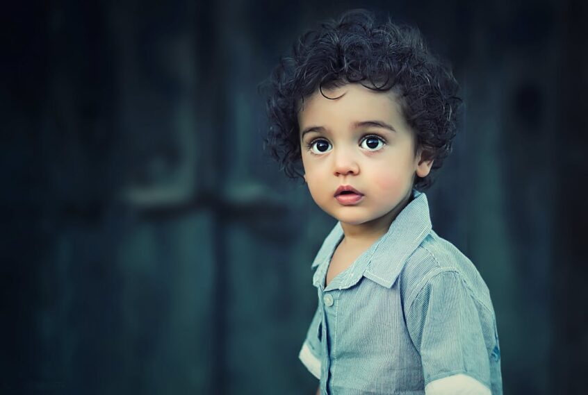 Toddler wearing grey button shirt