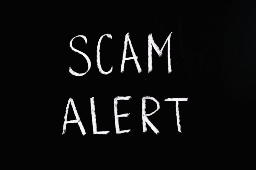 Scam Alert lettering on black background